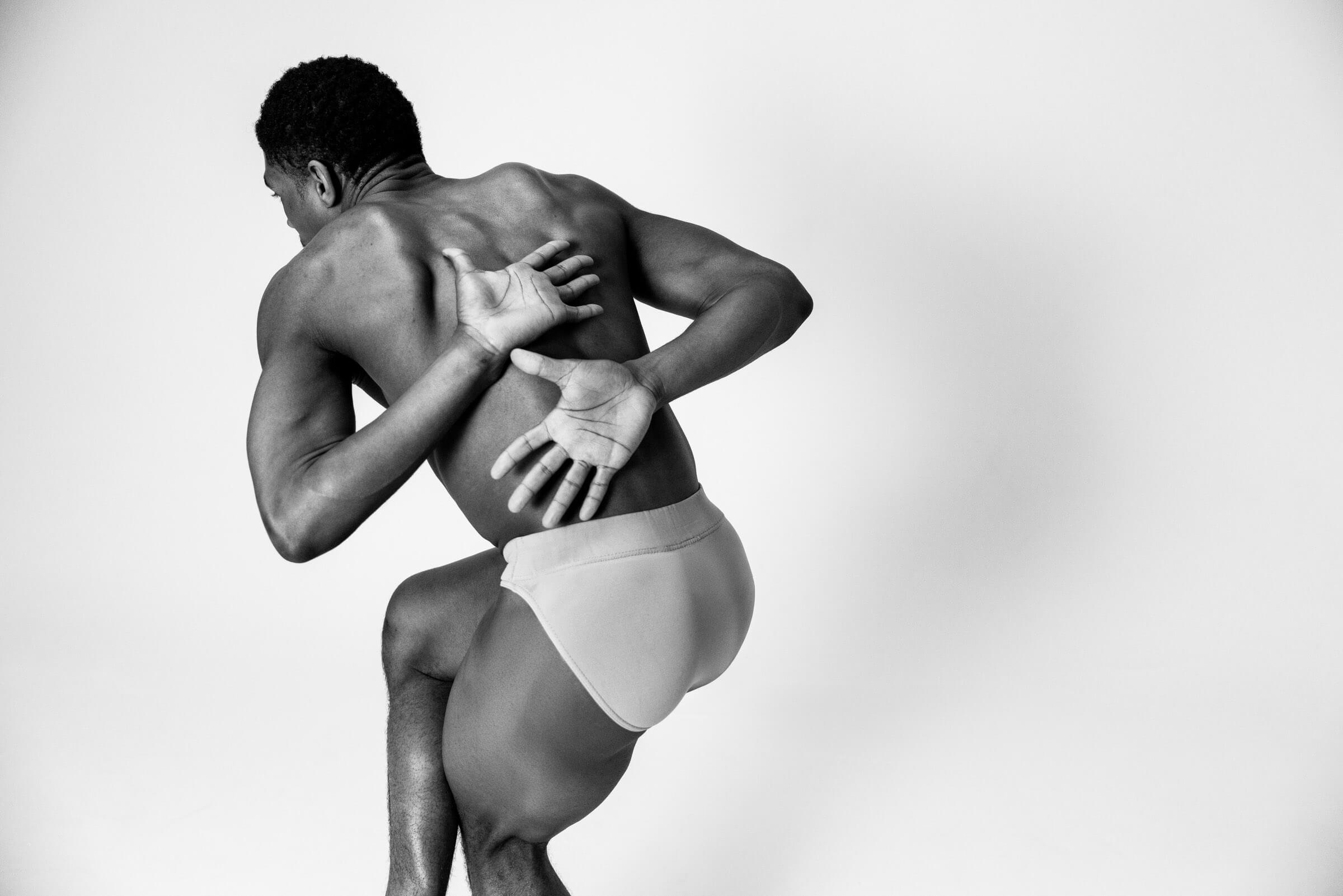 A dancer reaching behind their back, from the BNFTS studio shoot