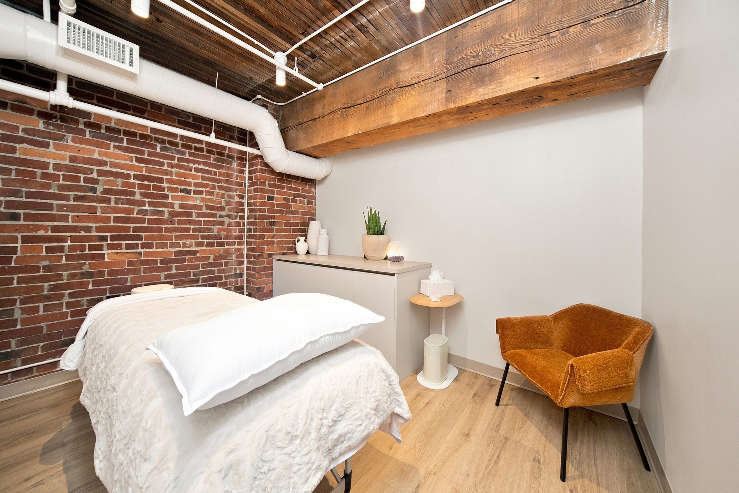A treatment room at BNFTS with a dressed table against a brick wall