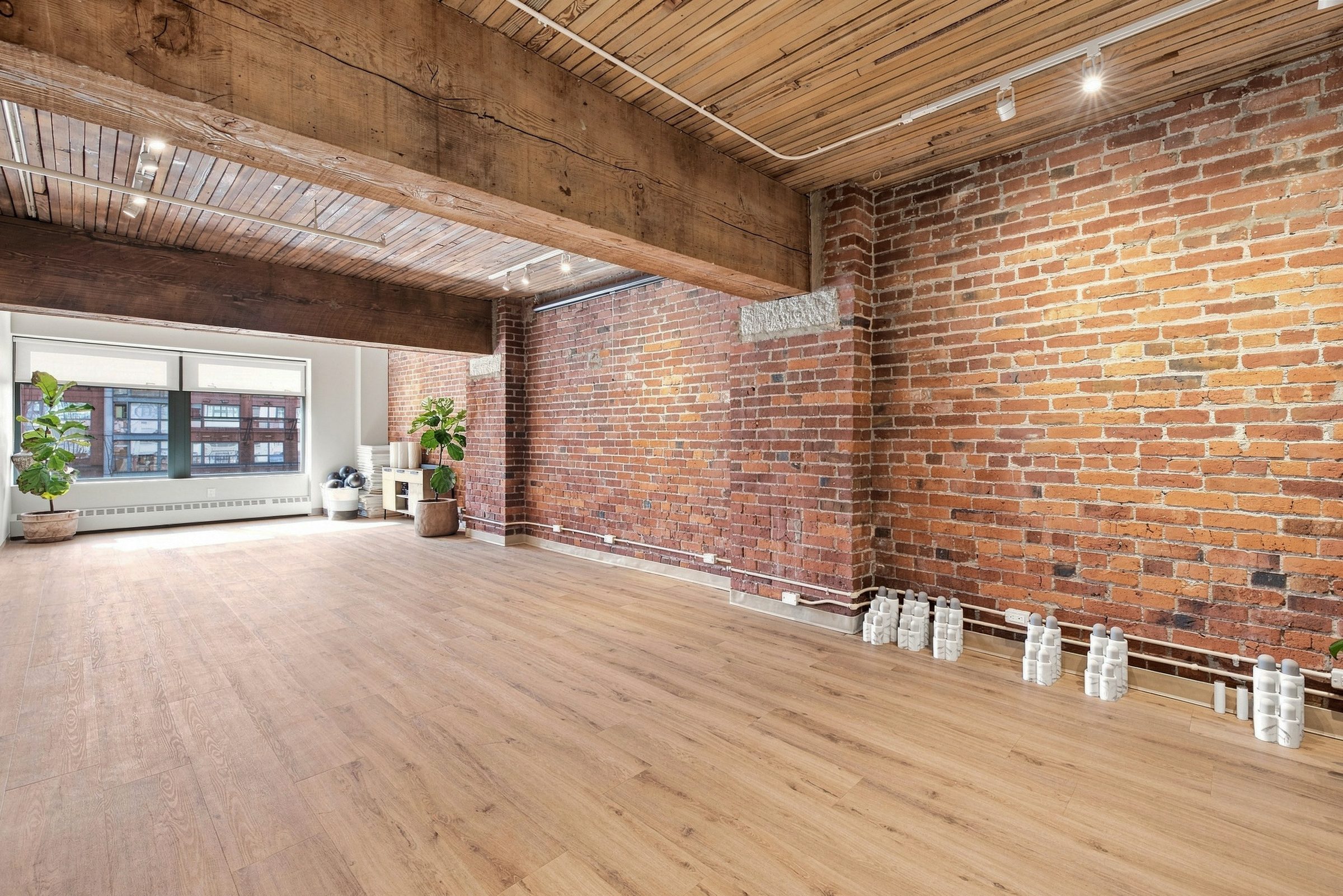 The movement studio at BNFTS — exposed brick, timber ceiling and an open oak floor