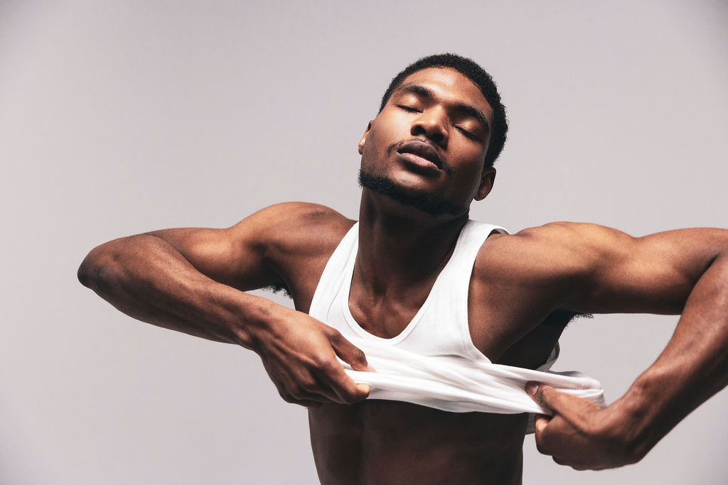A close portrait of a dancer in a white tank, head tilted back and eyes closed, from the BNFTS studio shoot