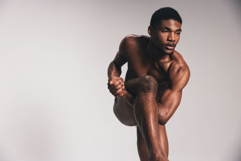 A nude dancer crouched forward with one leg extended, from the BNFTS Unbound campaign
