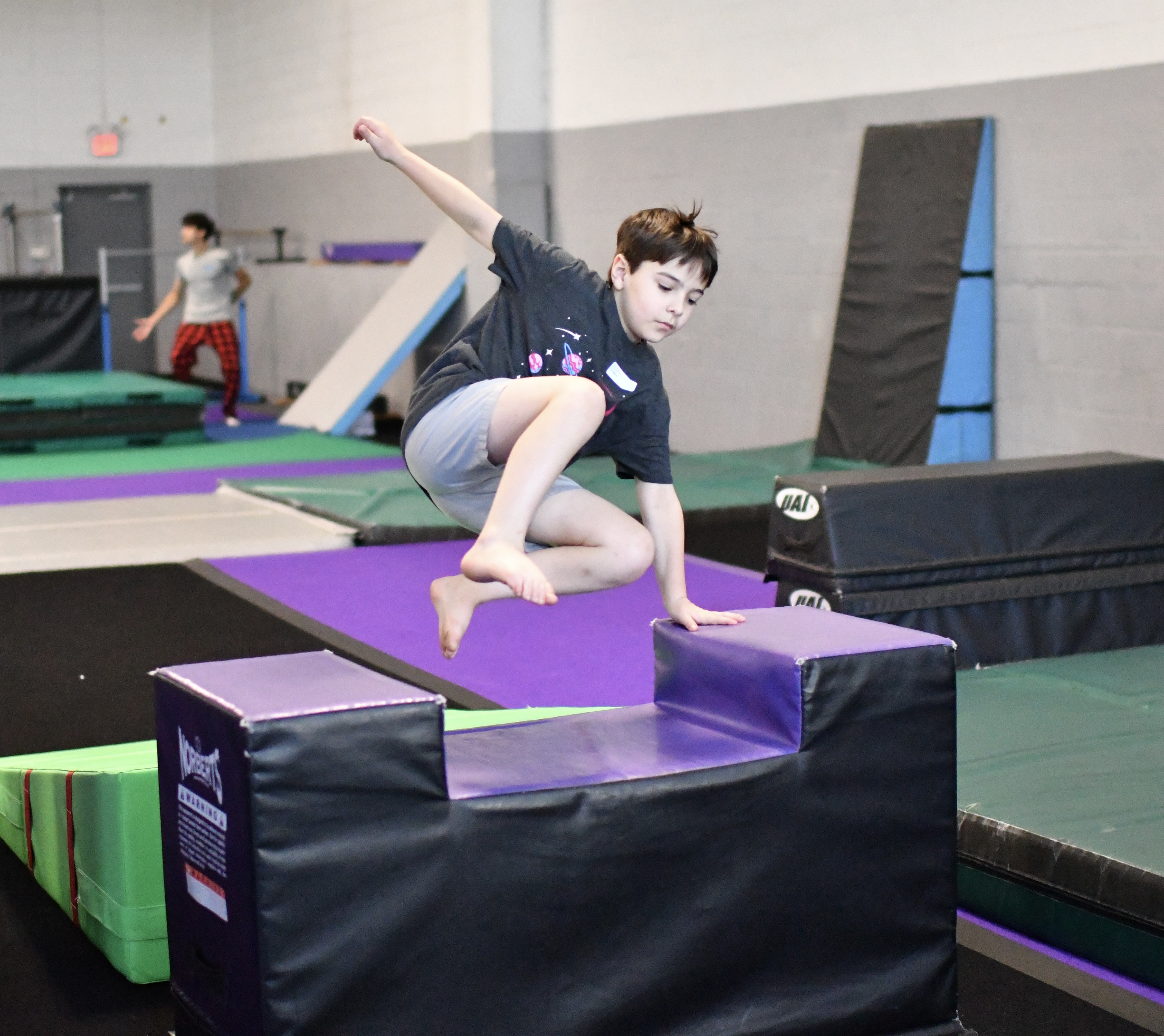 Student training on the parkour floor at Bolt Parkour in North Bethesda