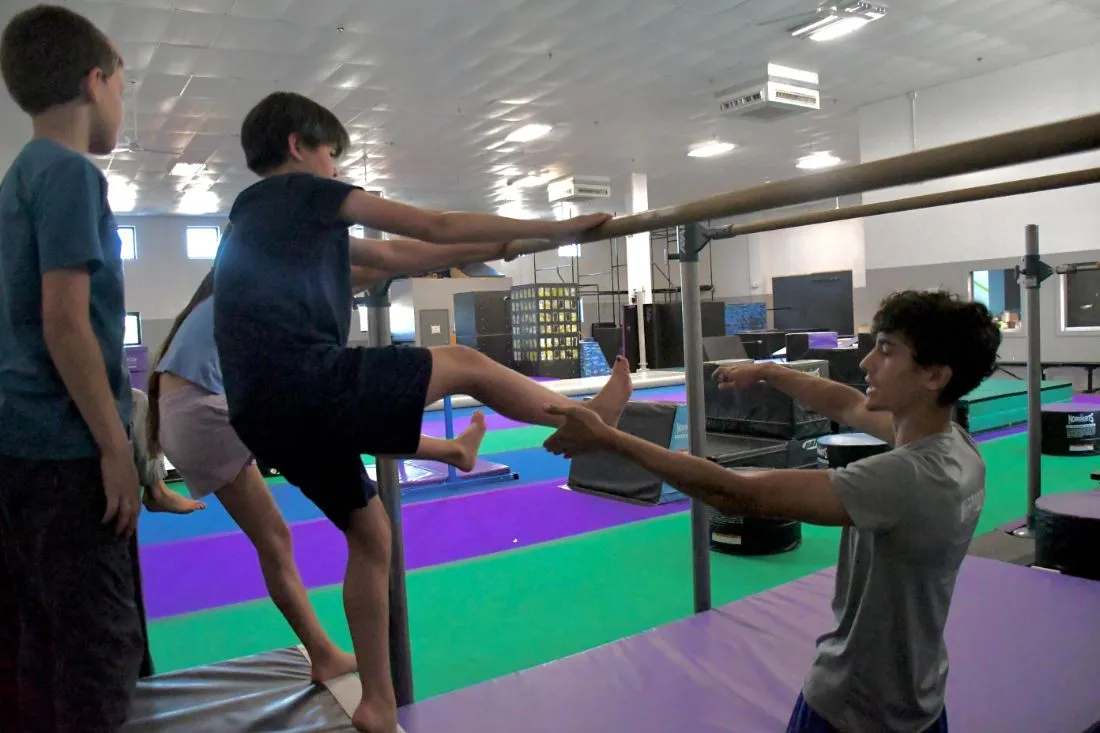 Coach holding a target for a kick drill in Tricking class