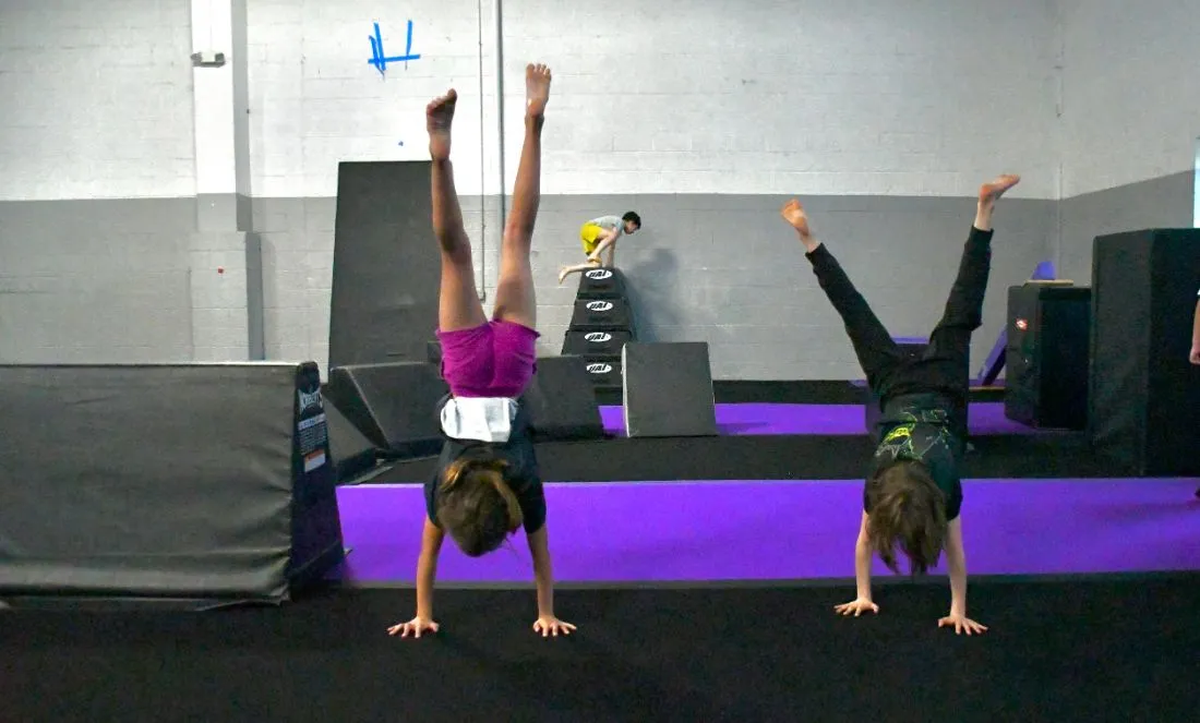 Campers holding handstands at School's Out Camp at Bolt Parkour