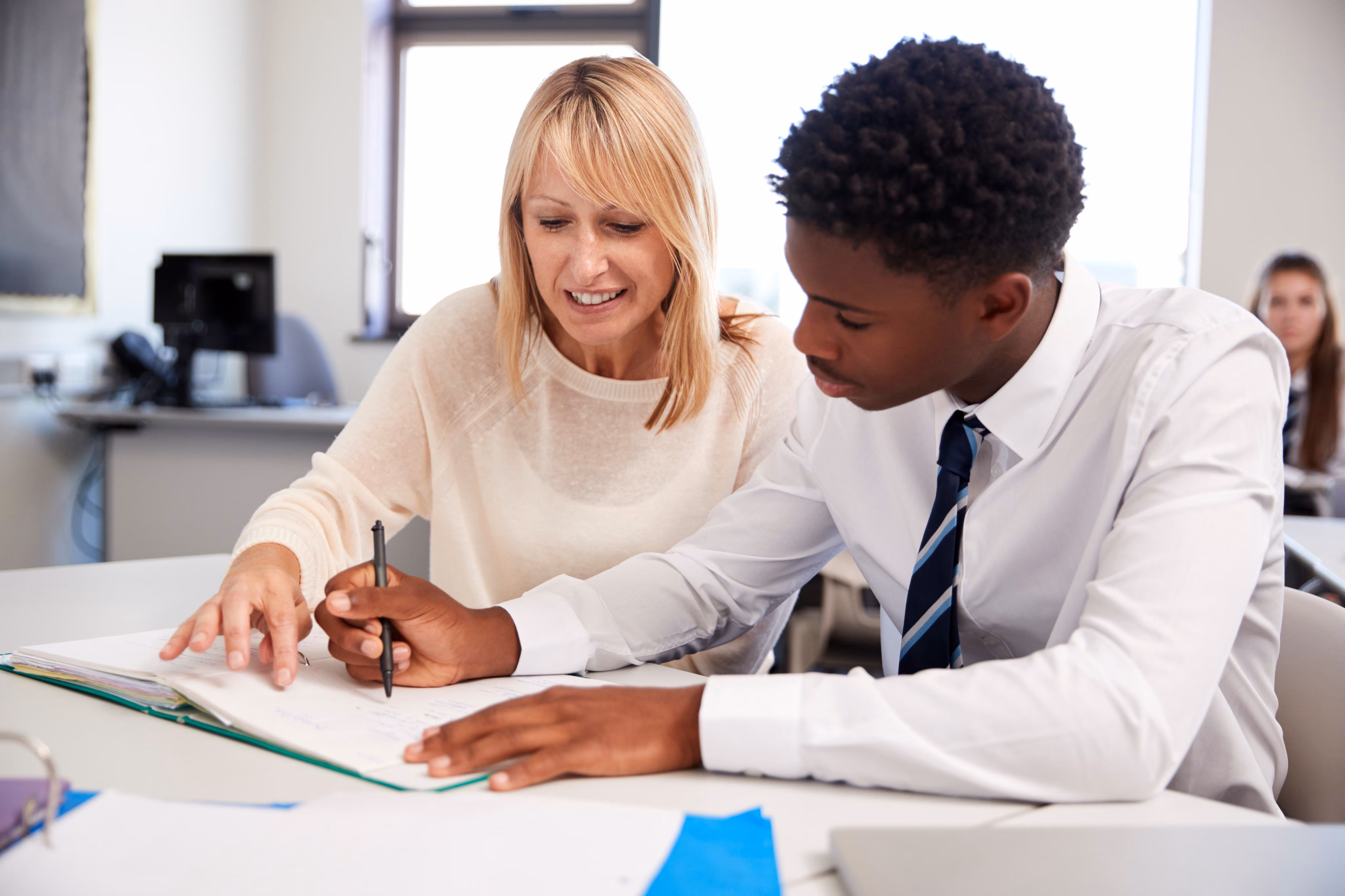 Teacher helping student