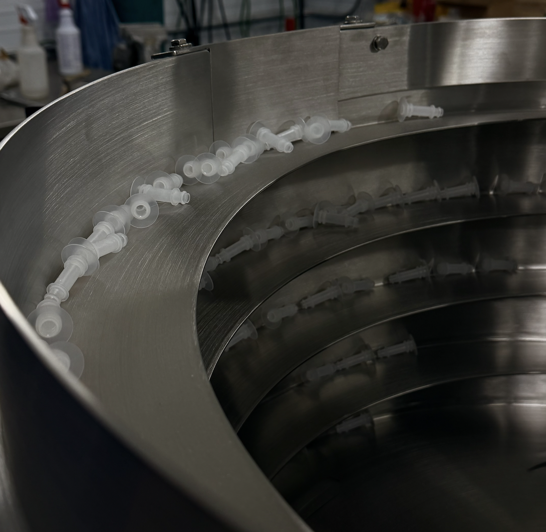Vibratory bowl feeder handling medical device parts