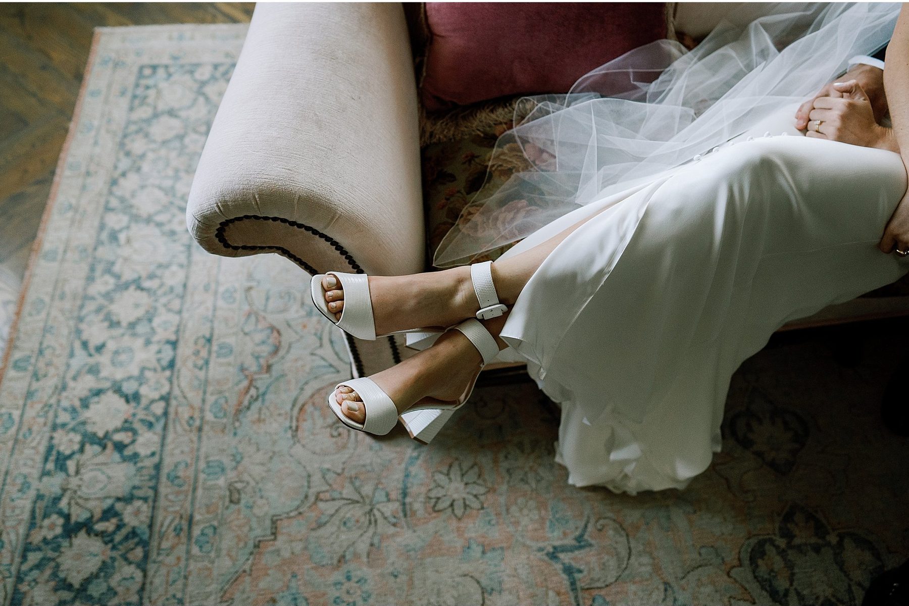 Wedding shoes and a veil on a rug