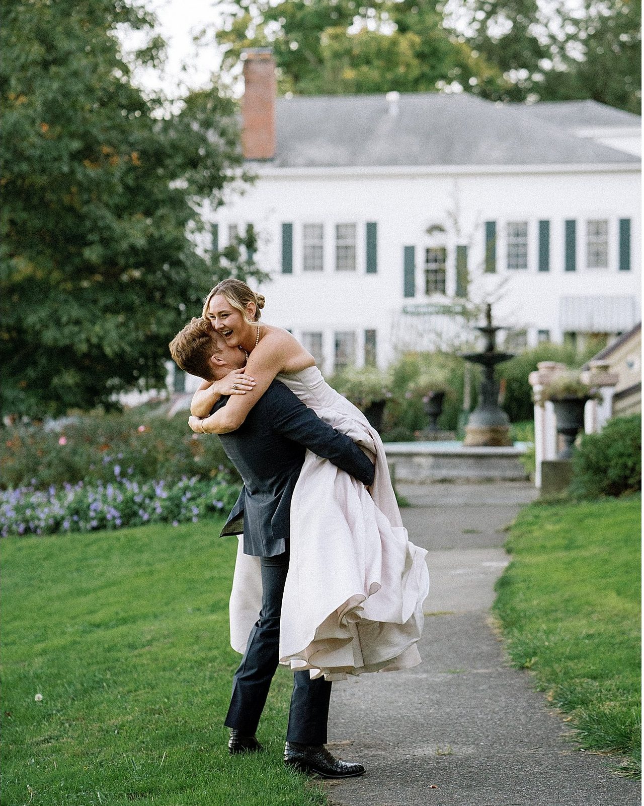 Guests lifting the couple in celebration.