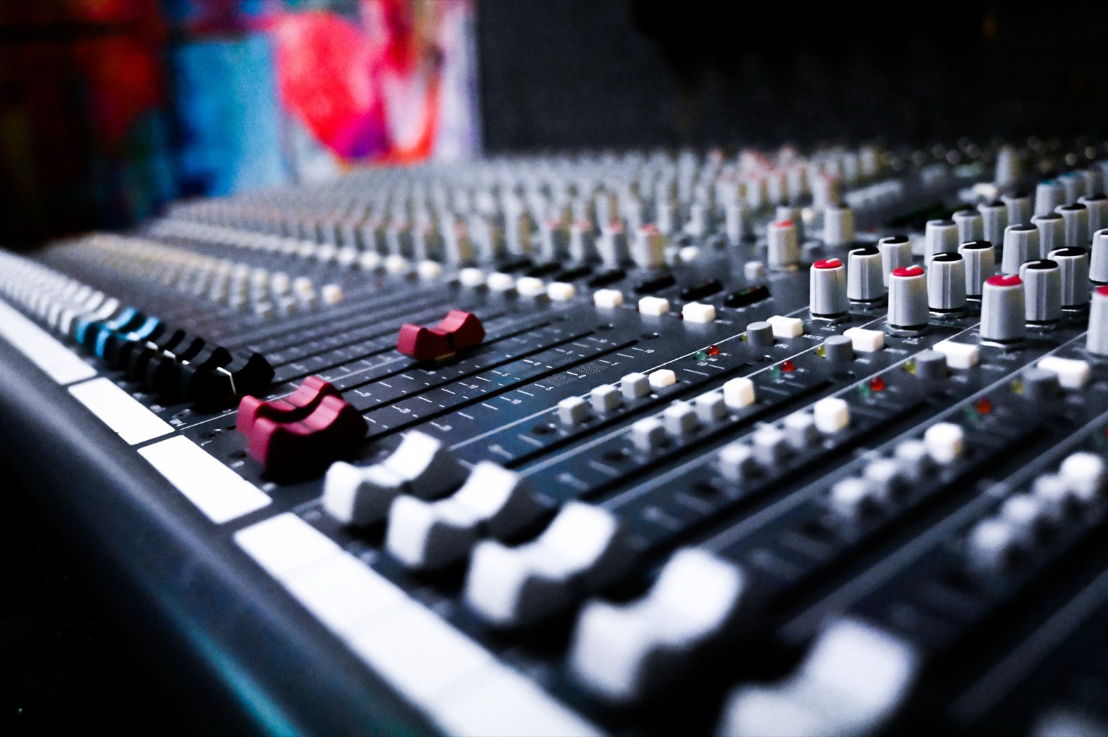 Close-up of a mixing console's faders and knobs