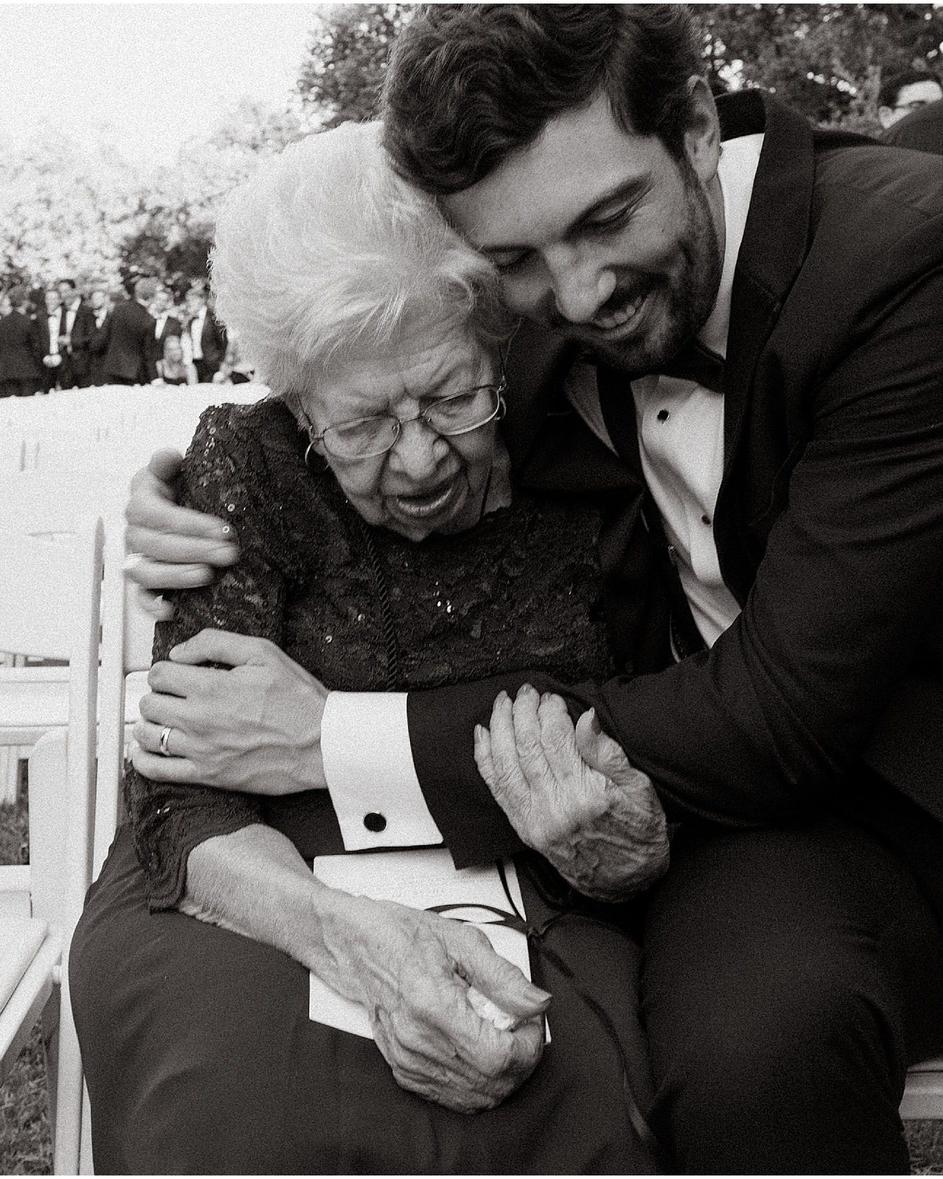 Black and white, the groom embracing his grandmother