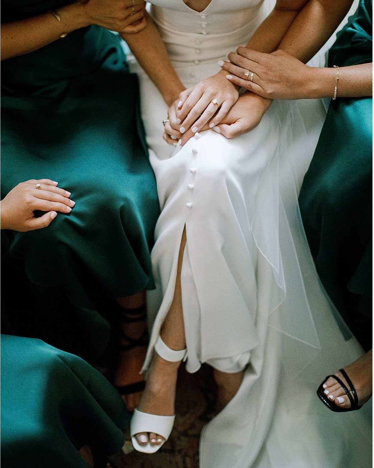 Hands resting on the wedding dress