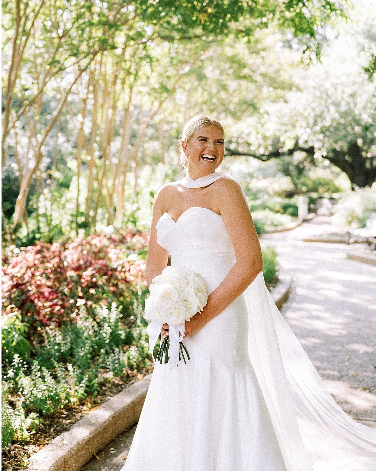 The bride laughing on a garden path