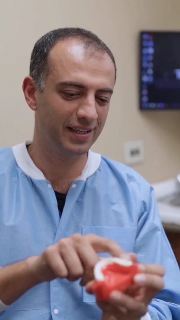 Dr. Ilya Ames taking time to explain treatment with a dental model