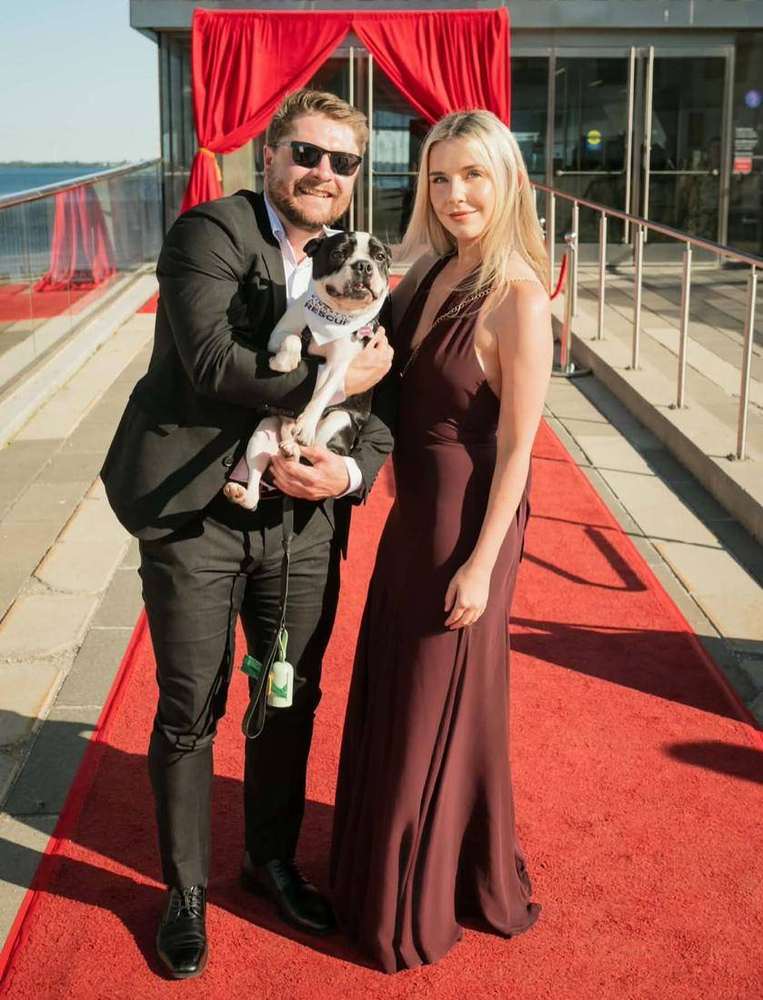 The New Day team with a rescue pup on the red carpet at the Forever Gala