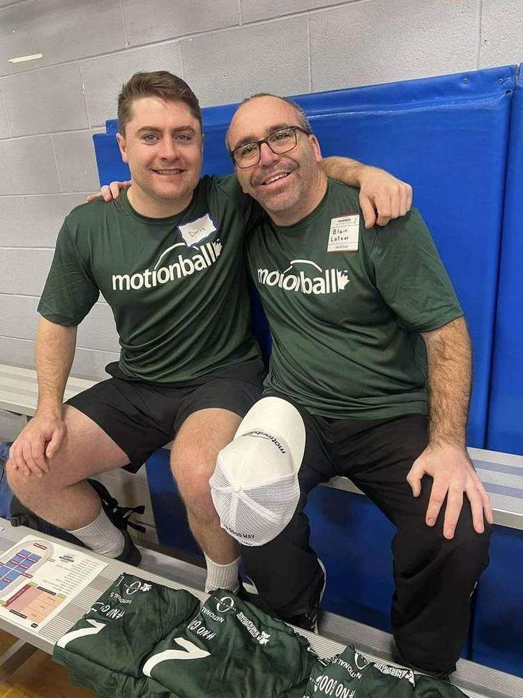 New Day volunteers with a Special Olympics athlete