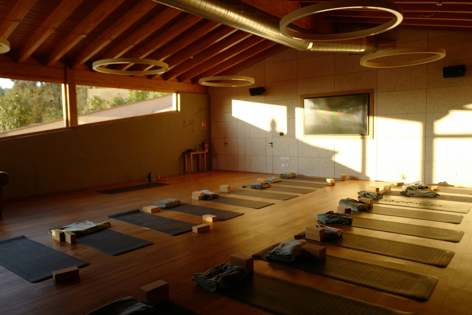 Yoga mats laid out in a bright studio before class