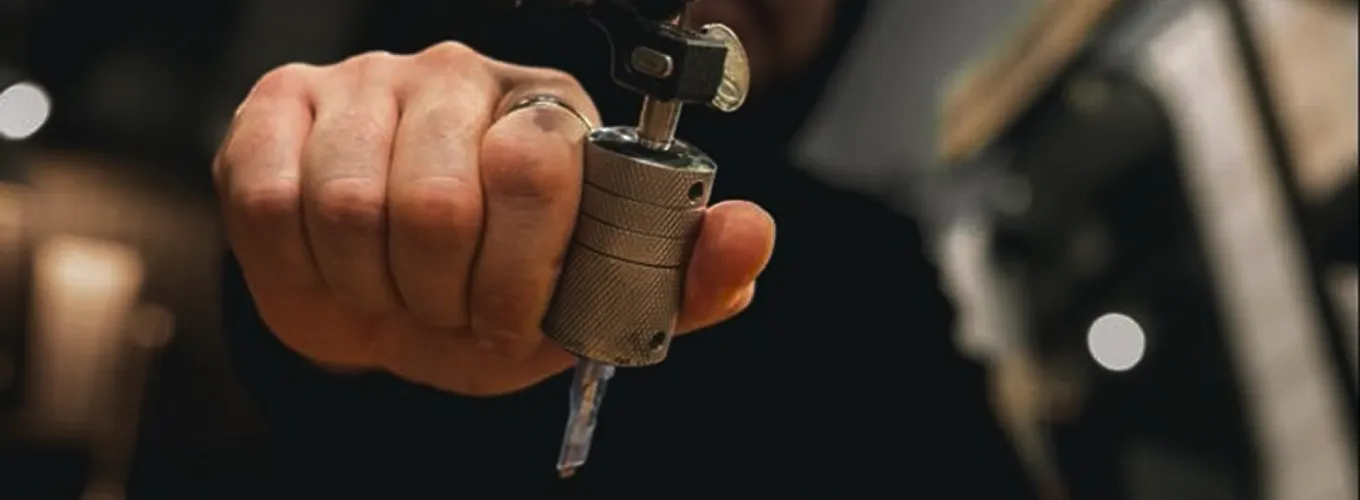 Tattoo artist holding a rotary tattoo machine