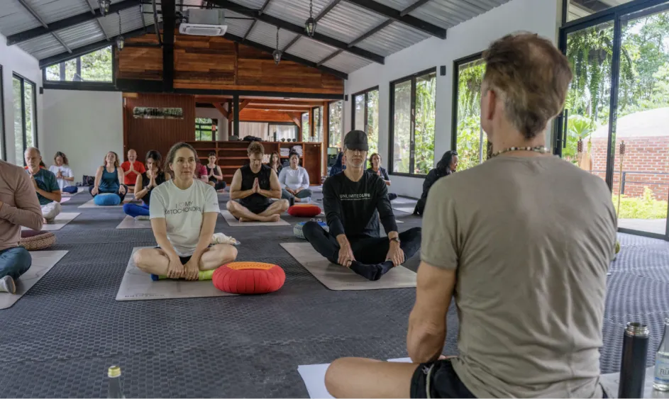 Group breathwork session inside an open-air lodge