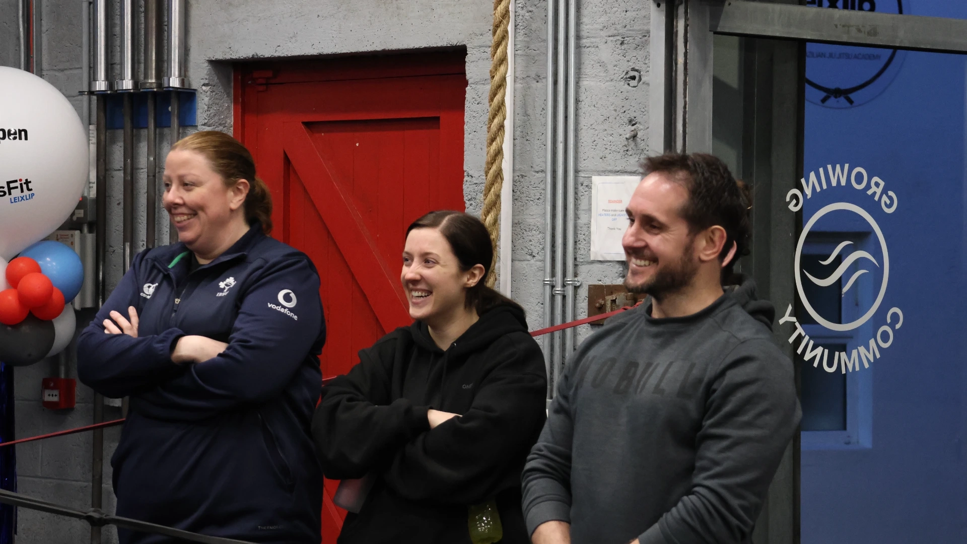 Two smiling CrossFit Leixlip members watching a class in the gym