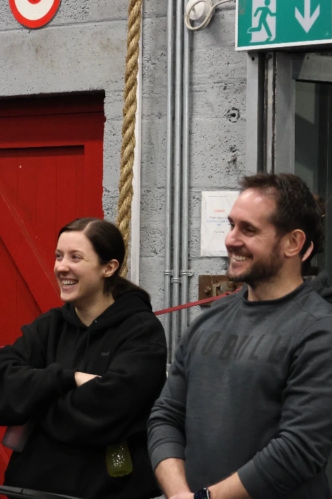 Two smiling CrossFit Leixlip members watching a class in the gym