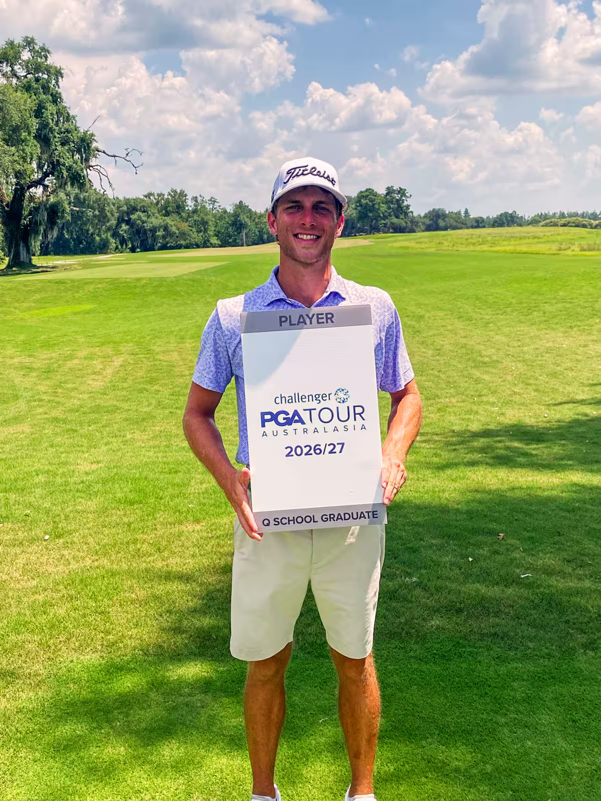 Austin Gean holding his 2026–27 Challenger PGA Tour of Australasia Q School Graduate sign on a golf course.
