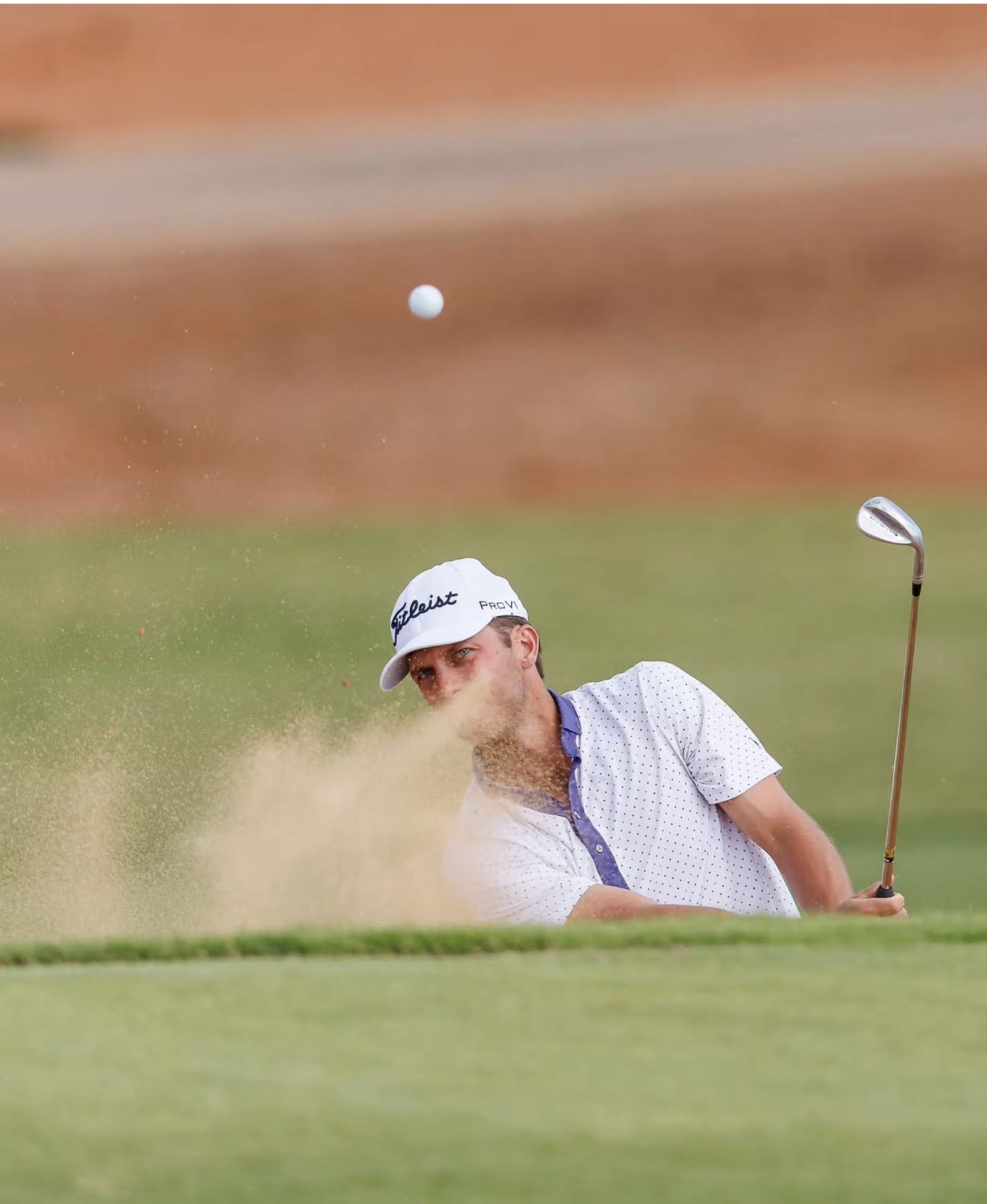 Austin Gean playing a bunker shot.