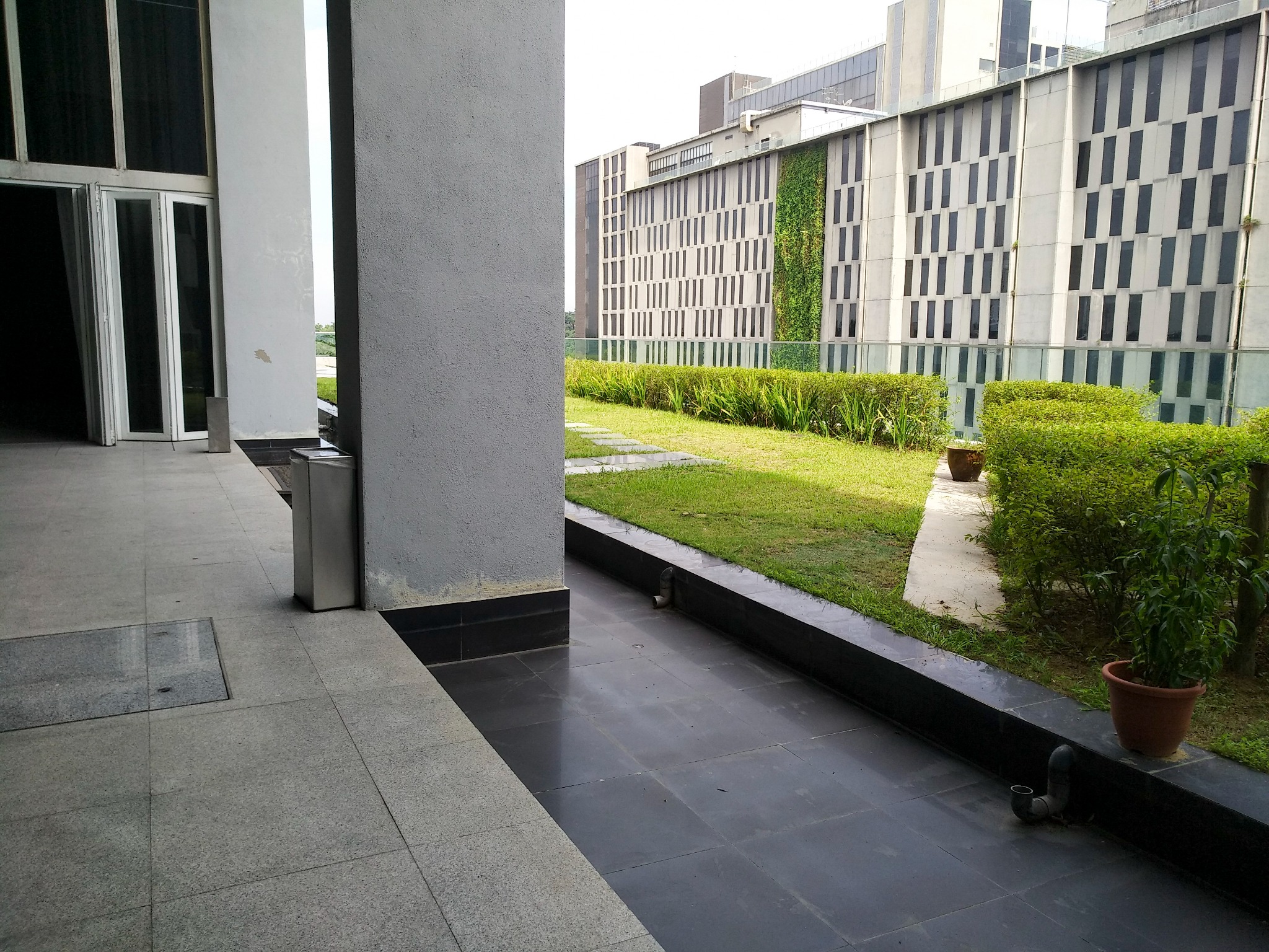 Onecity terrace and landscaped courtyard beside the building façade.