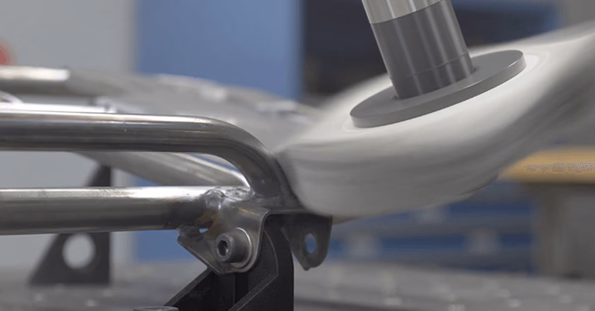 A PushCorp buffing wheel on a robot arm polishing a welded stainless steel tubular part