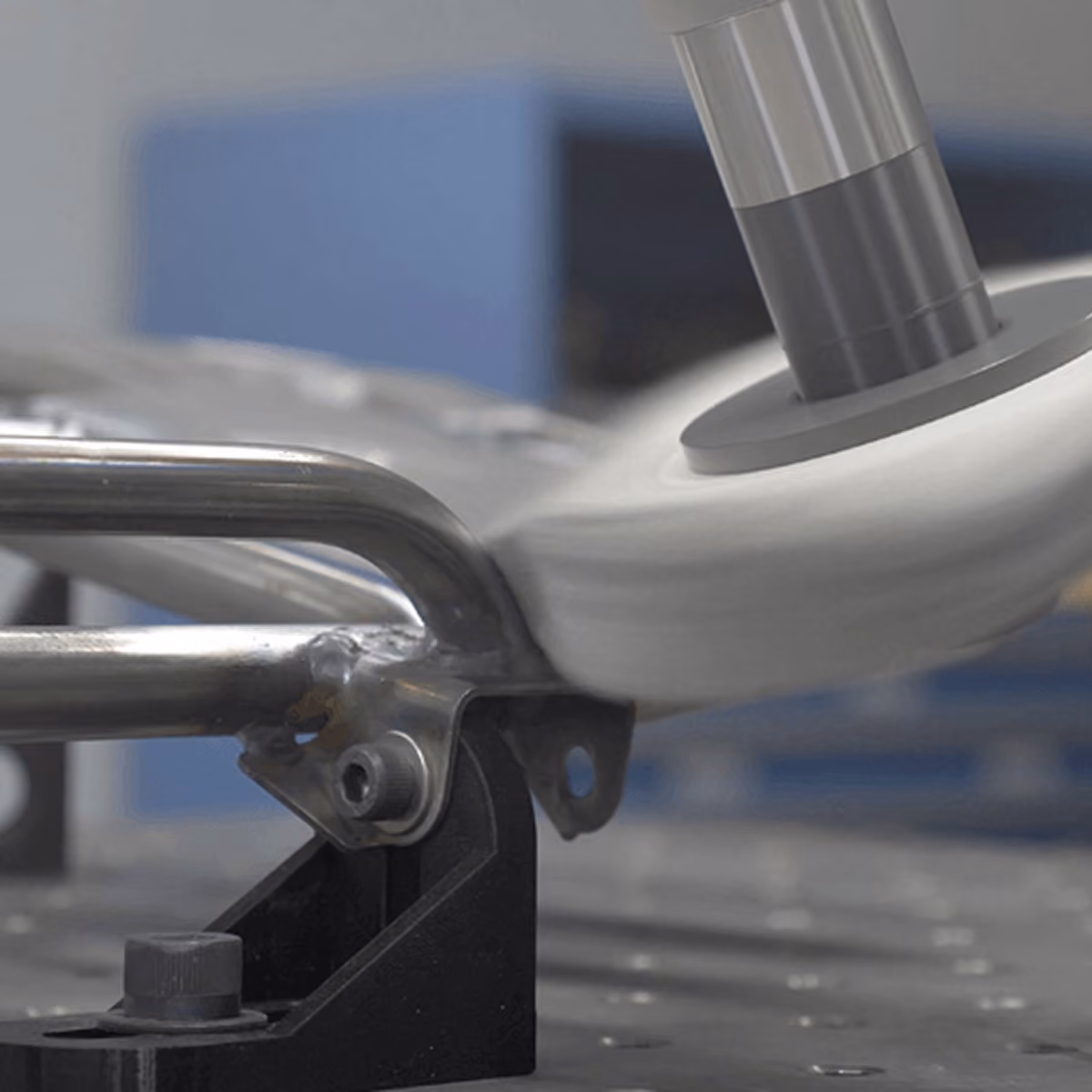 A PushCorp buffing wheel on a robot arm polishing a welded stainless steel tubular part