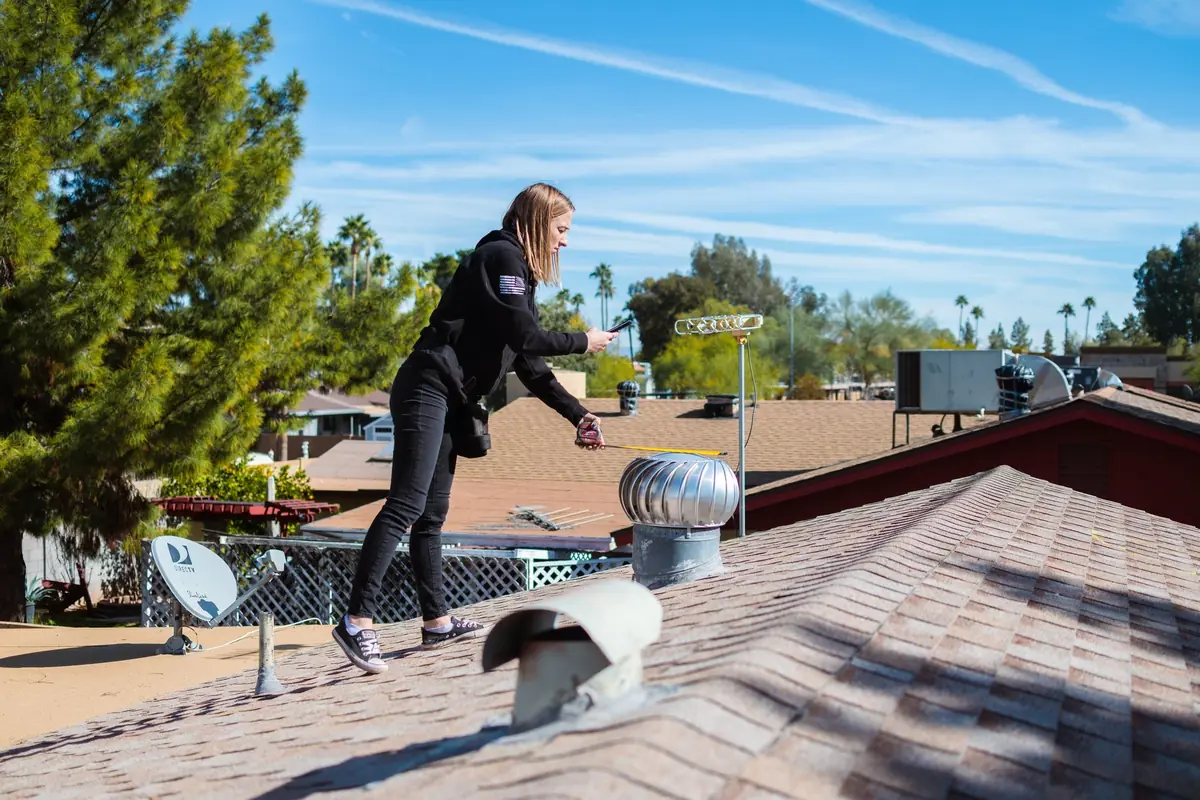 Axis Roofing on a shingle roof in Tempe for a roof inspection for a leak caused by storm damage