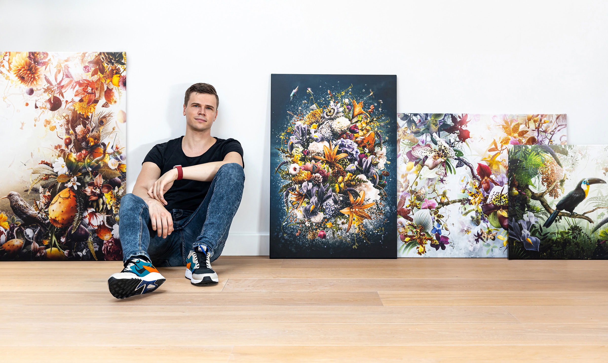Jesper Krijgsman sitting between his artworks