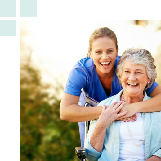 A woman in a wheelchair is assisted by a nurse, showcasing compassion and support in a healthcare setting.