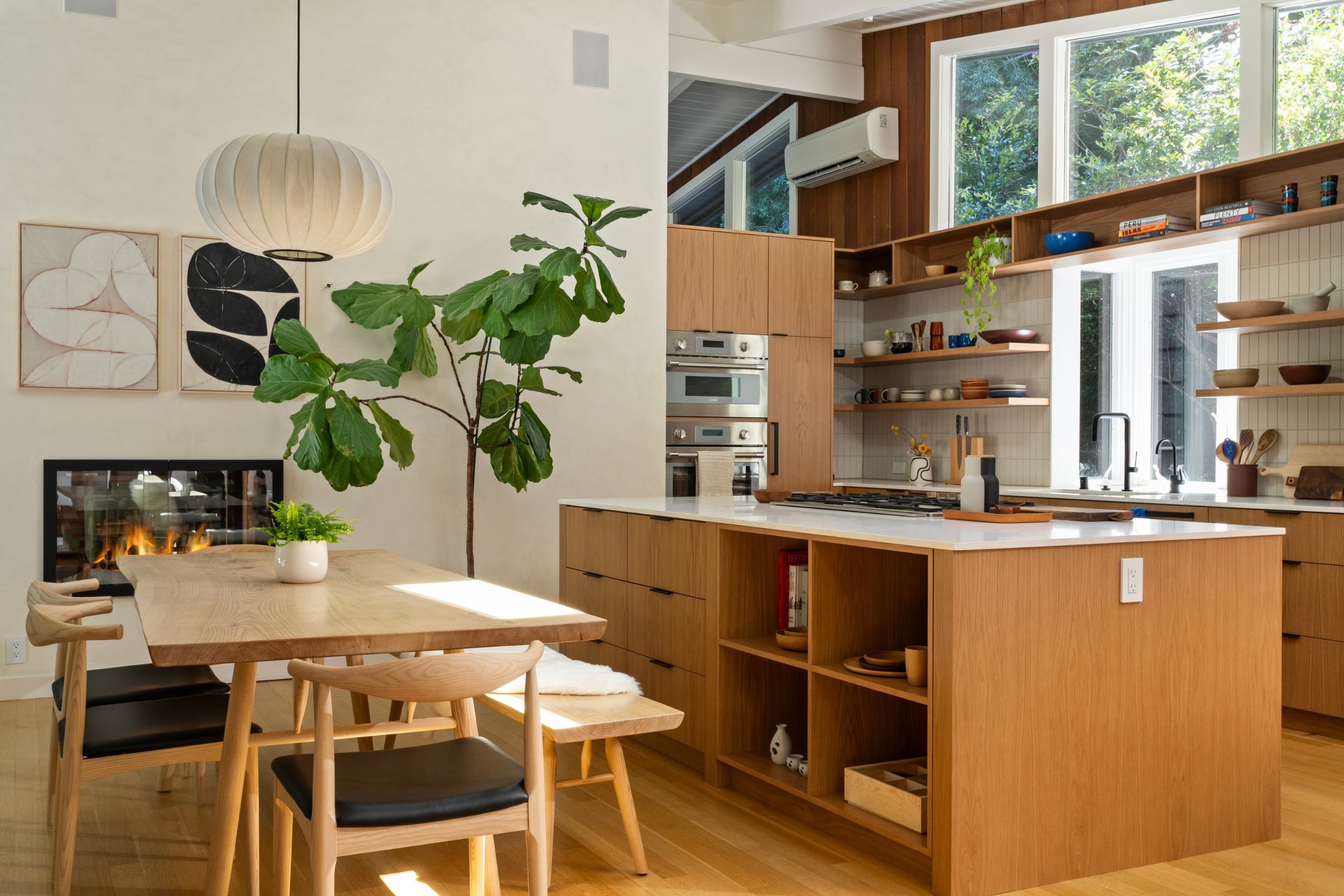 An oak kitchen and dining table under a paper lantern, San Francisco Bay Area. Real estate photography by Lumiful Media