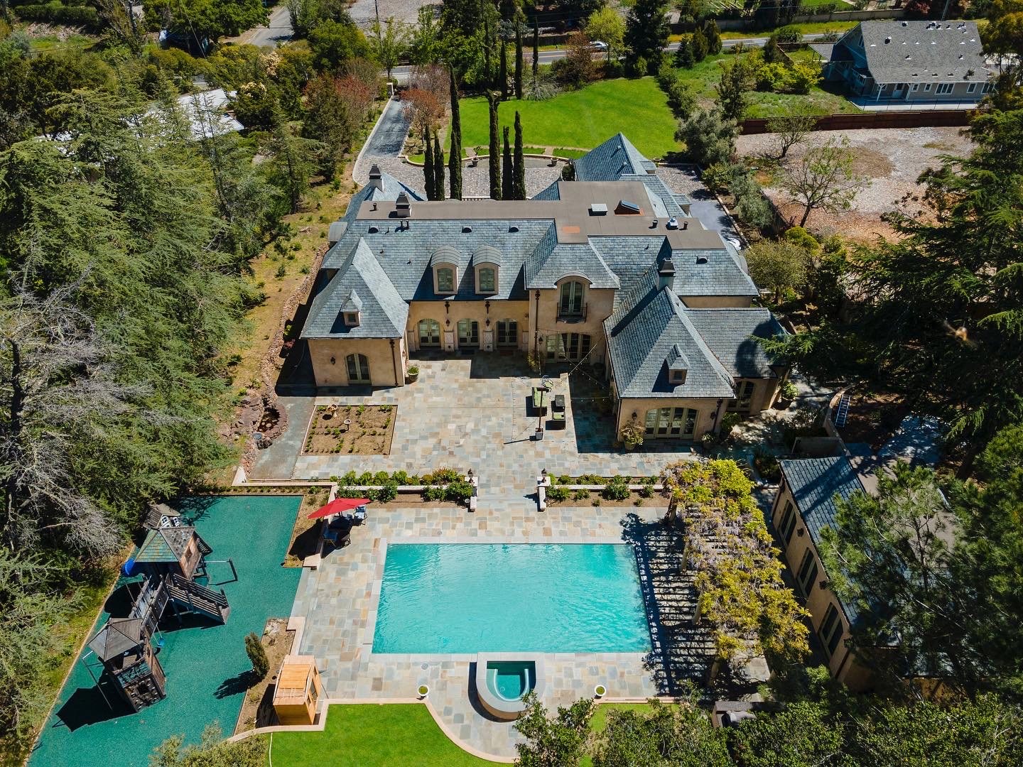 A stone estate, pool and garden from above, San Francisco Bay Area. Drone photography by Lumiful Media