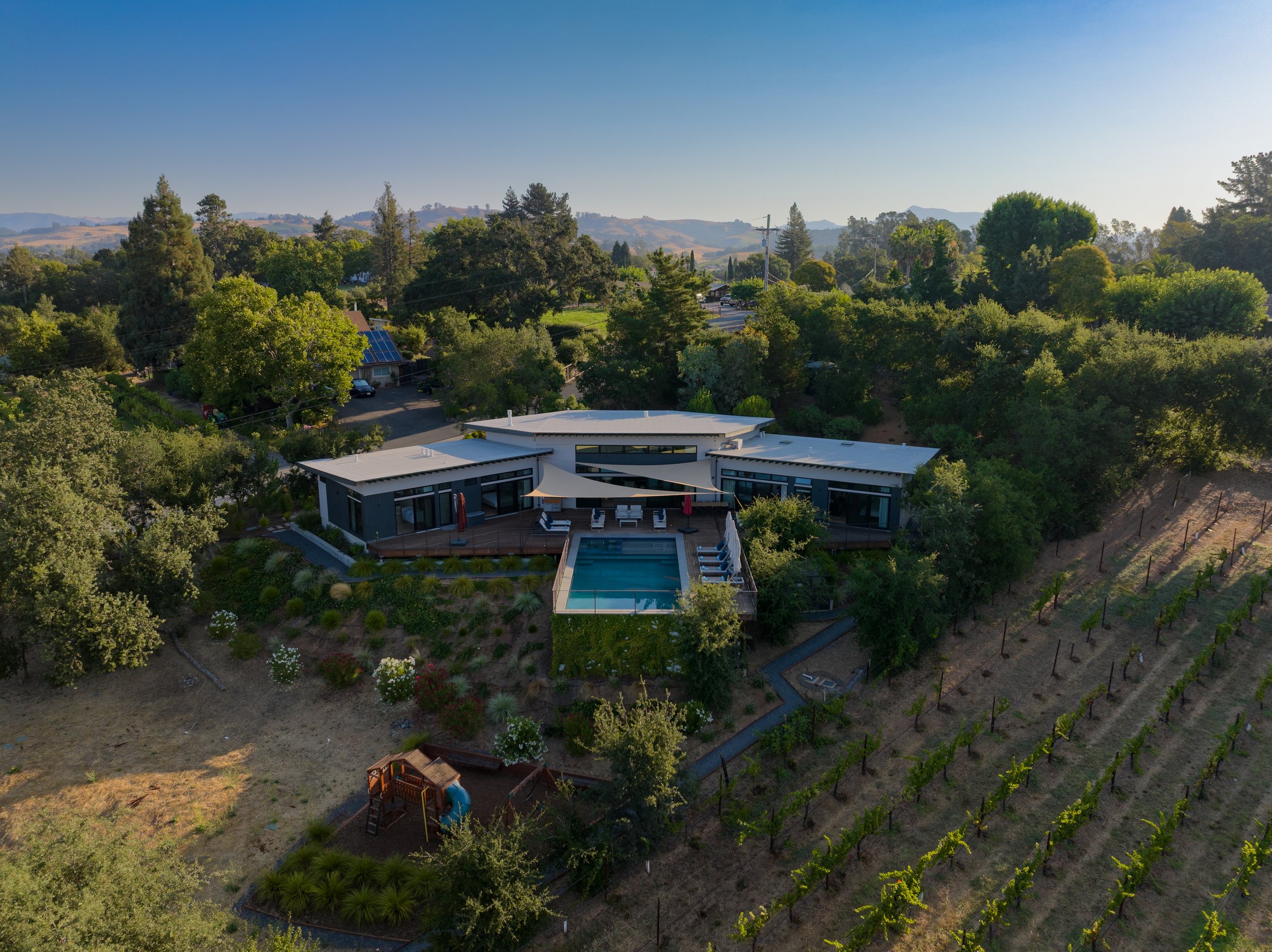 A modern home and pool above vineyard rows, San Francisco Bay Area. Drone photography by Lumiful Media