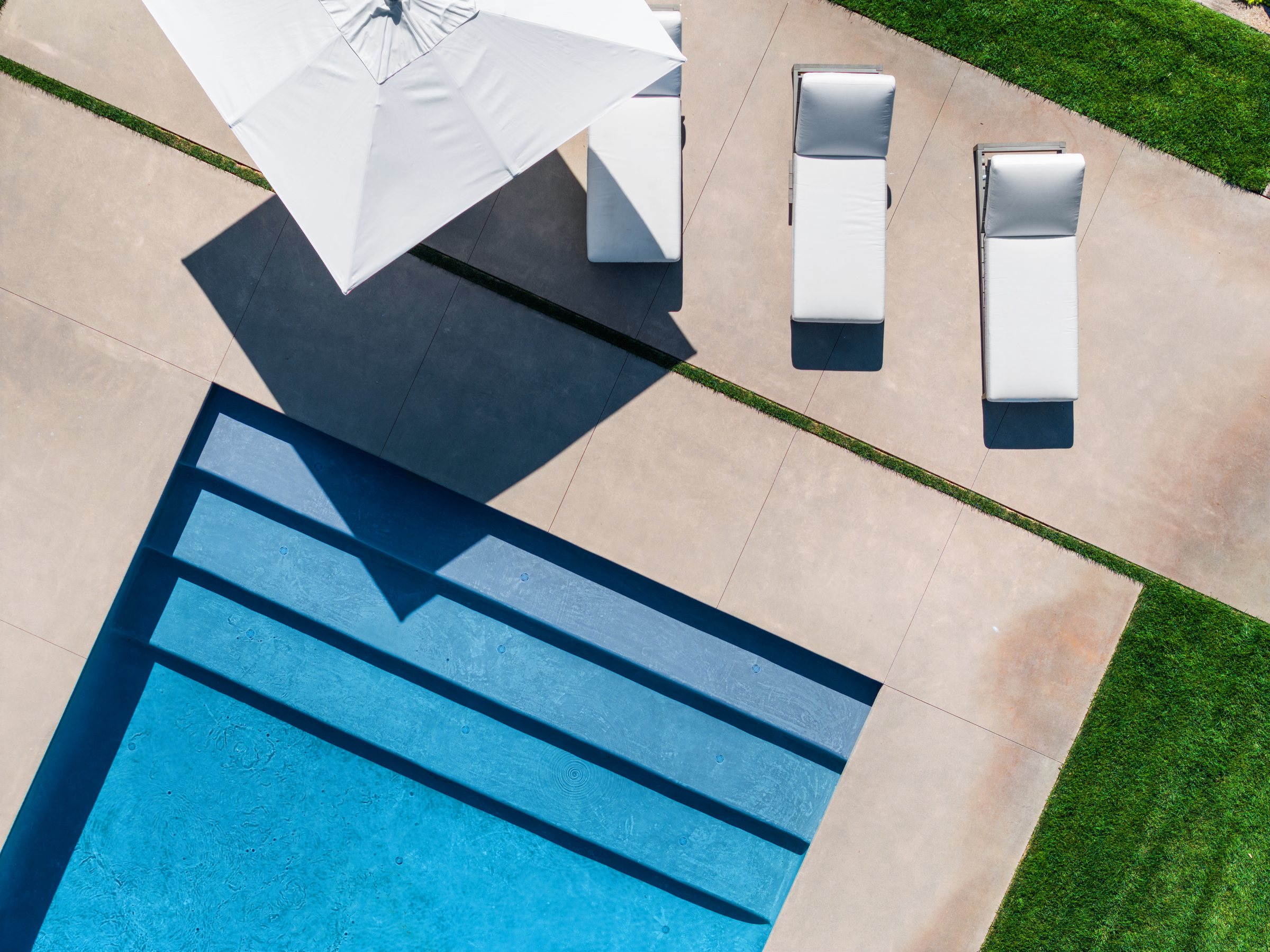 Pool steps and lounge chairs from directly above, San Francisco Bay Area. Drone photography by Lumiful Media