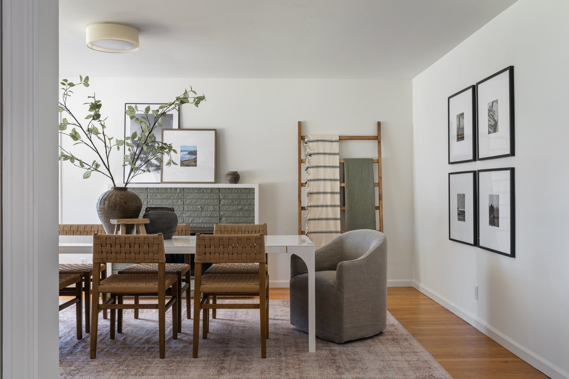 A dining room with framed prints and a garden branch, San Francisco Bay Area. Real estate photography by Lumiful Media