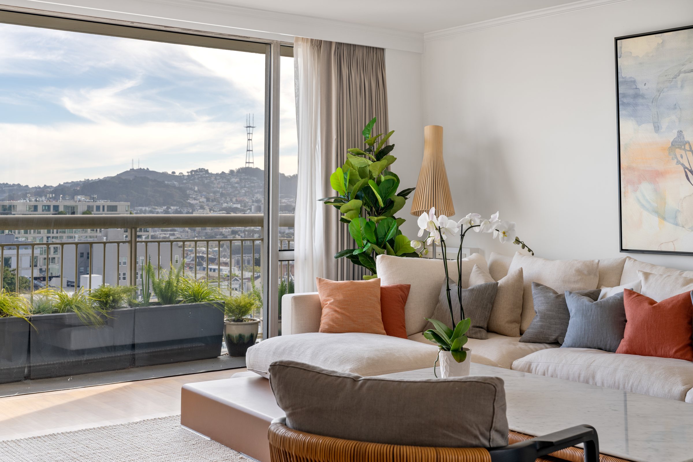 A living room with a balcony and city views, San Francisco. Real estate photography by Lumiful Media
