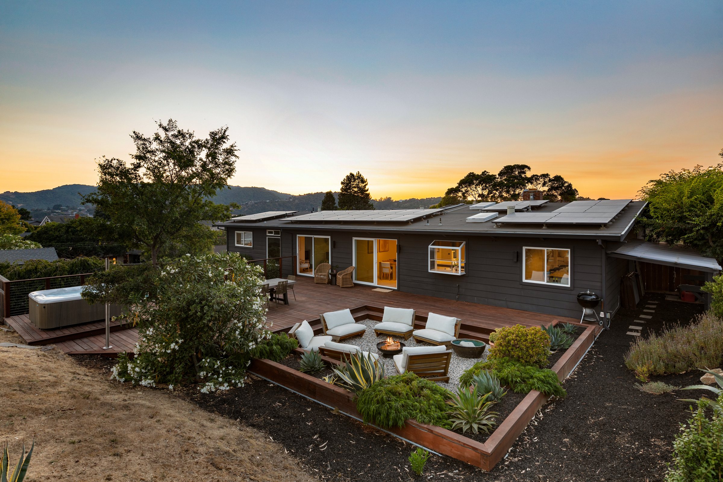 A home and fire pit deck above the bay at dusk, San Francisco Bay Area. Twilight real estate photography by Lumiful Media