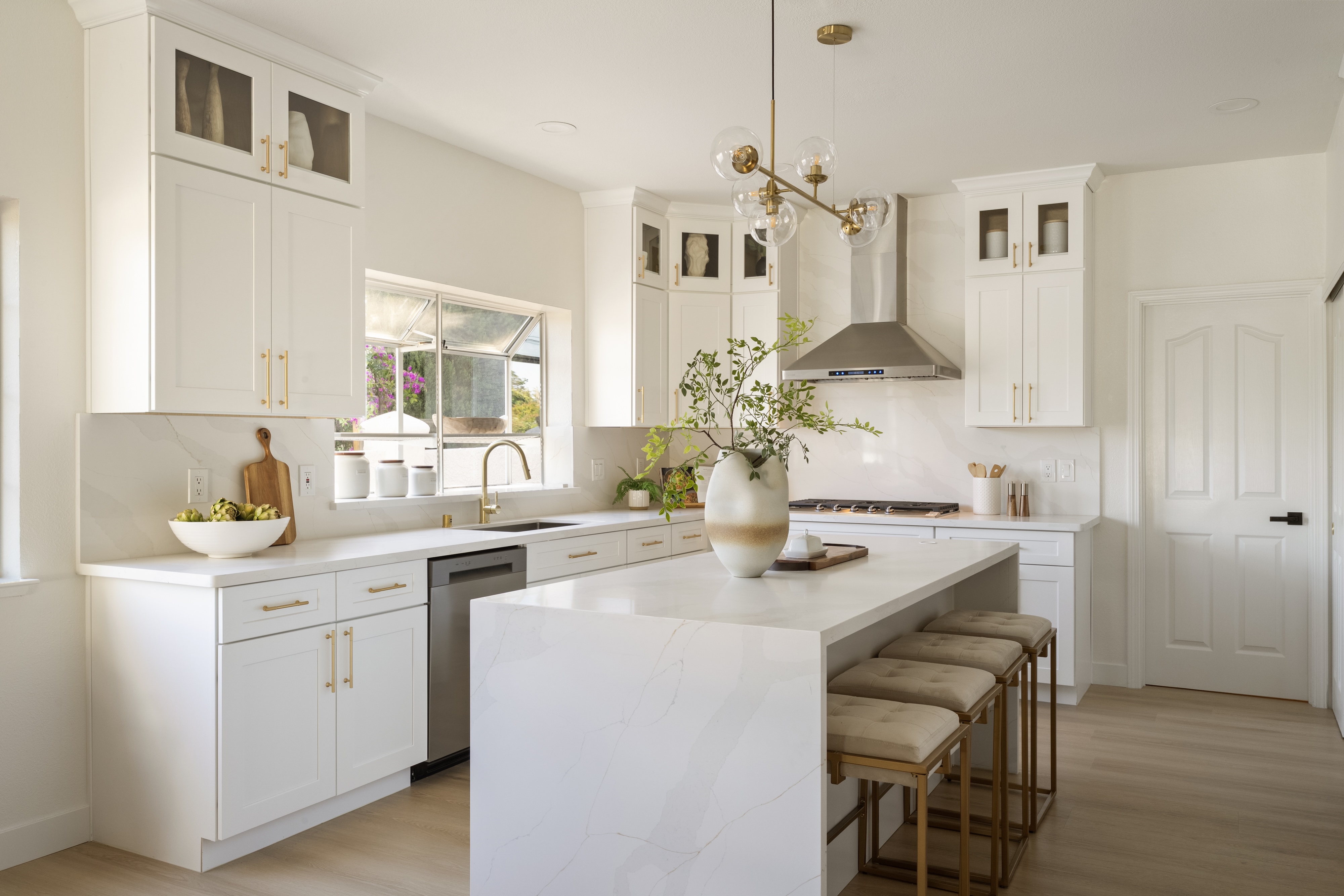 A white kitchen with a marble waterfall island, Cupertino. Real estate photography by Lumiful Media