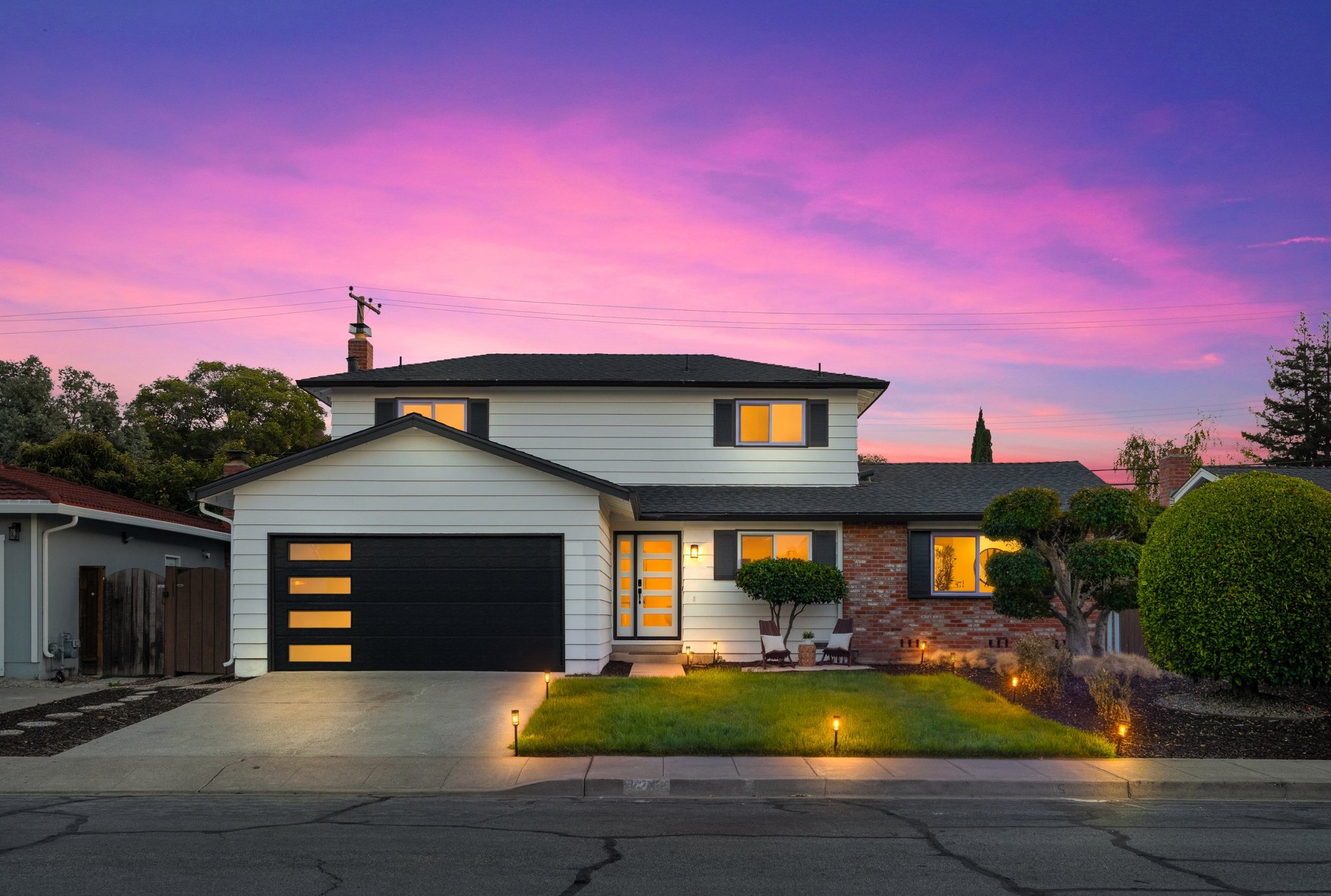 The same home shown as a virtual twilight, with lit windows and a pink sky, San Francisco Bay Area. Virtual twilight by Lumiful Media