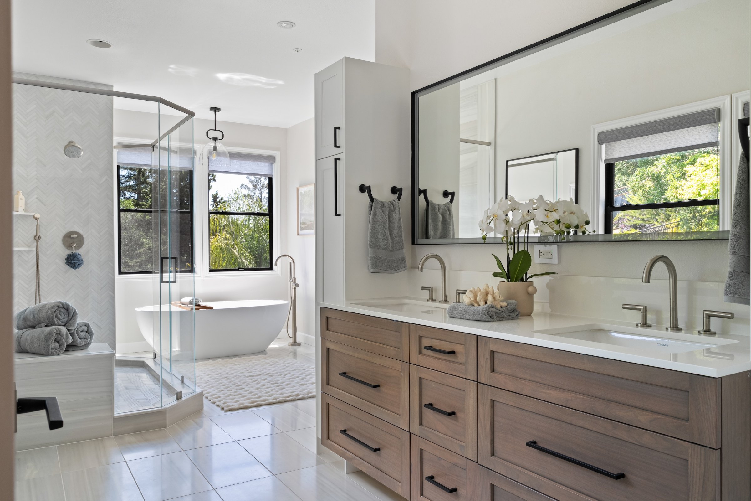 A primary bath with a freestanding tub, a glass shower and a wood vanity, Marin County. Real estate photography by Lumiful Media
