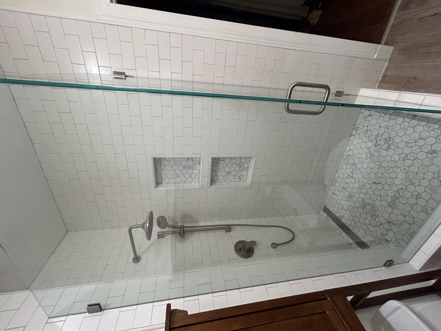 White subway tile shower with frameless glass