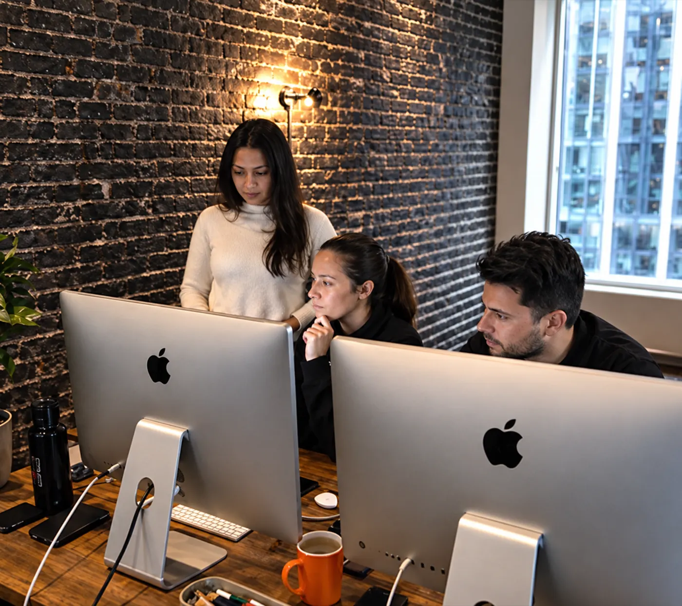 Consultants reviewing work together at their desks