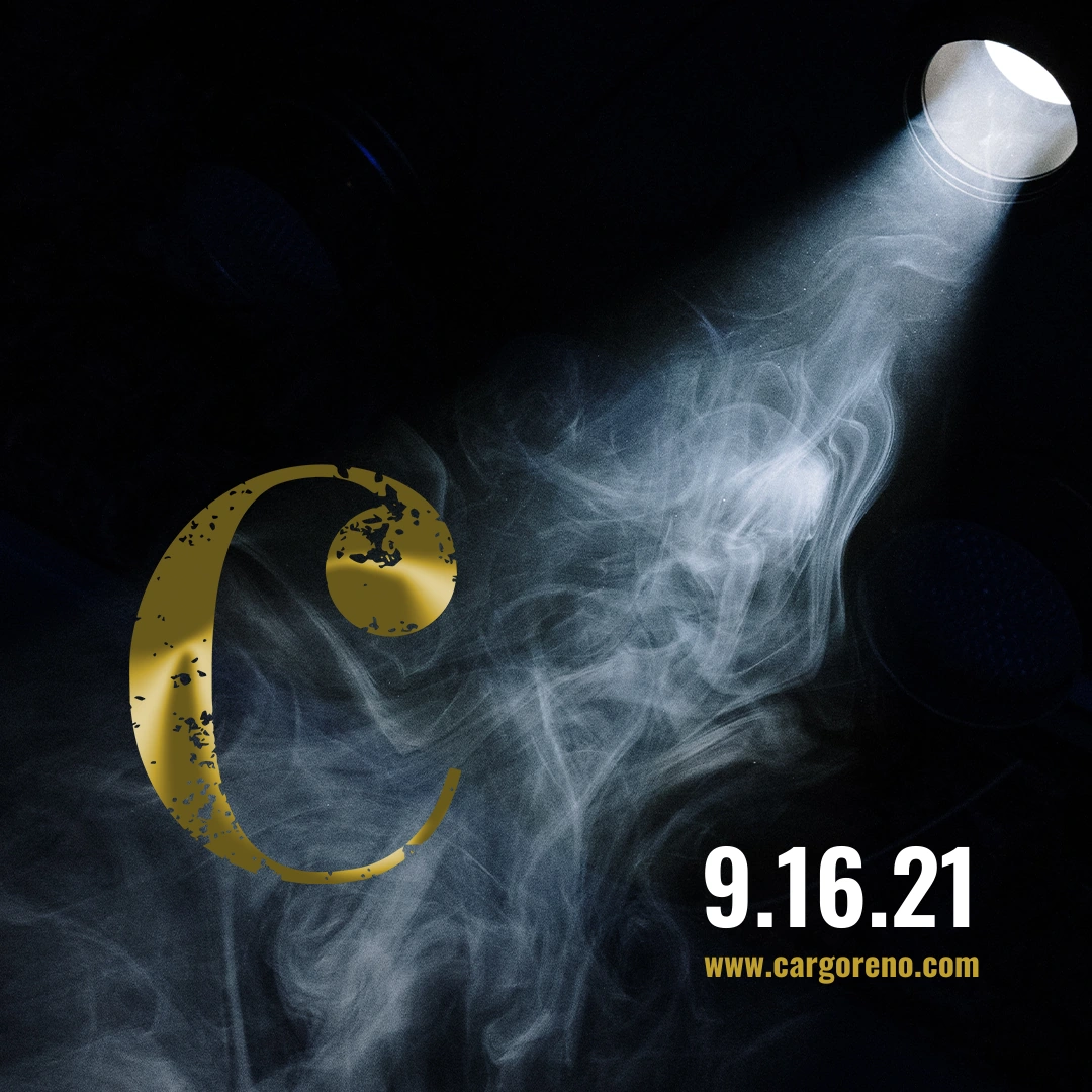Original September 2021 Cargo show-drop teaser with a gold C in a smoky stage-light beam.