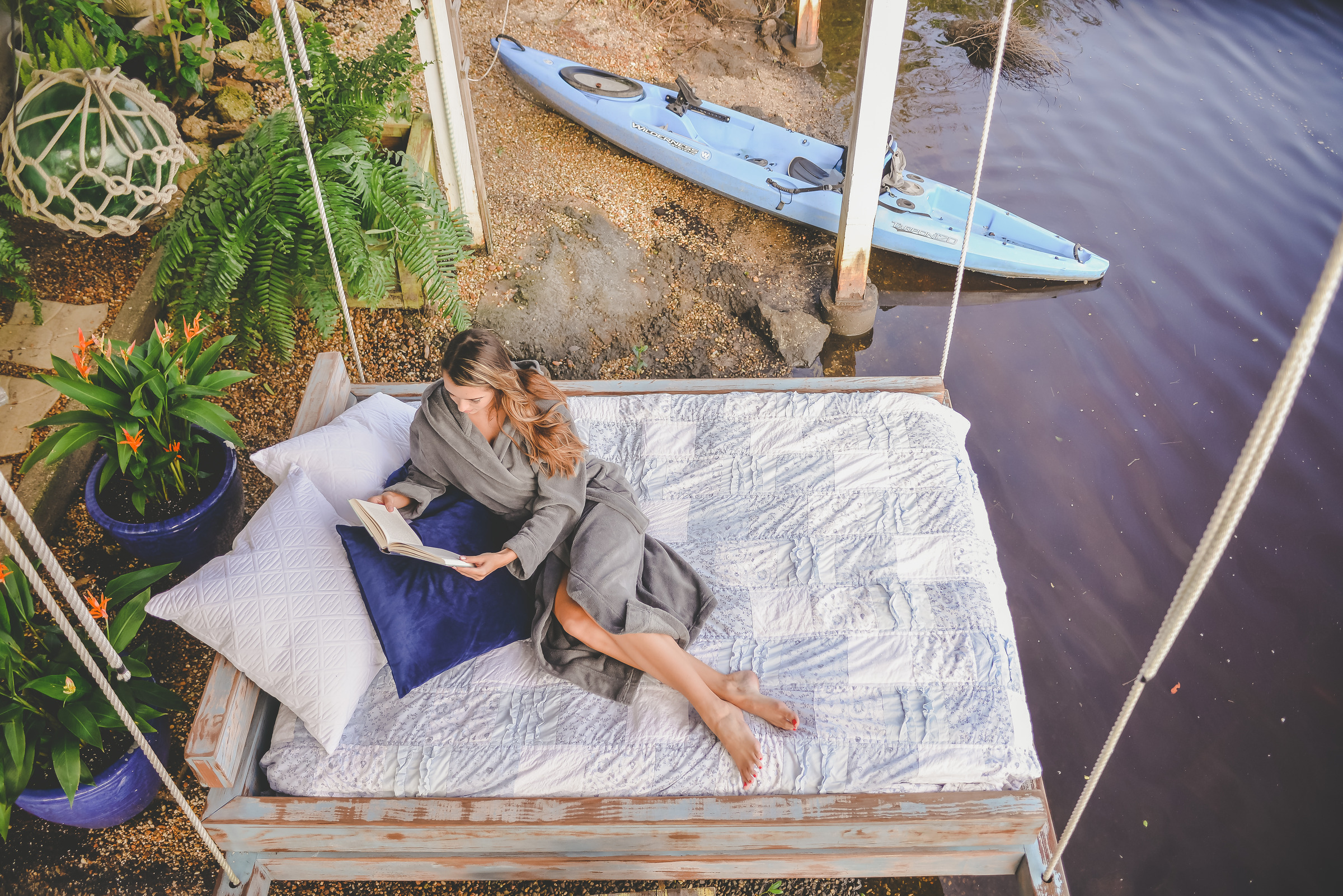 A woman reading outdoors in an Alexander Del Rossa robe