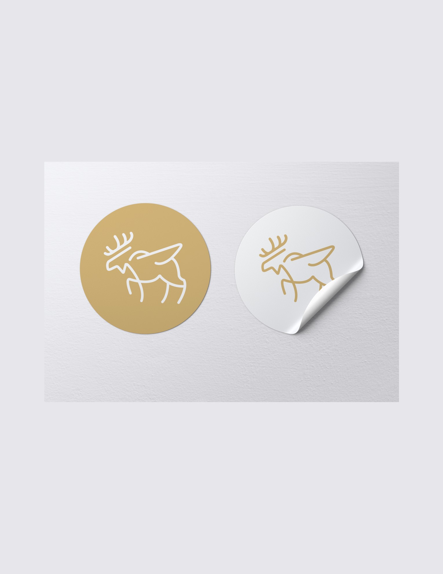 Gold and white circular Flying Moose sticker mockups on a sheet.