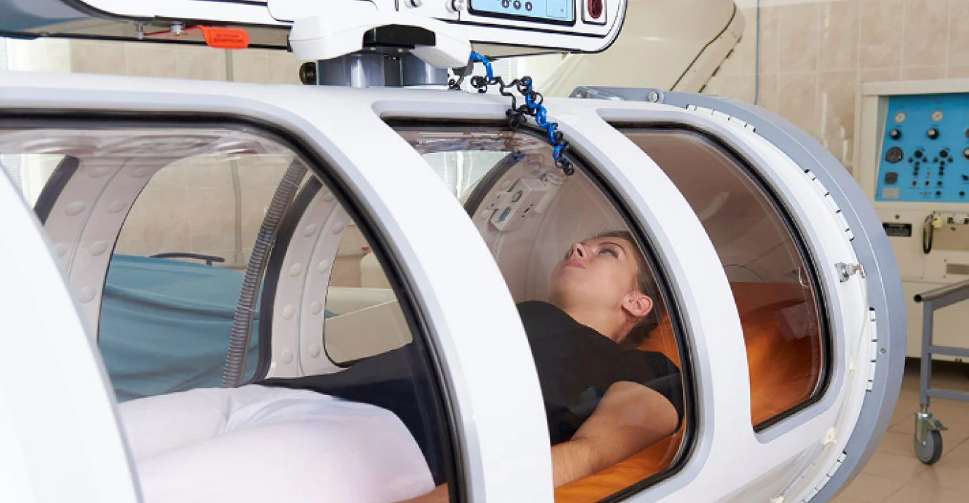 Patient lying inside a hyperbaric chamber
