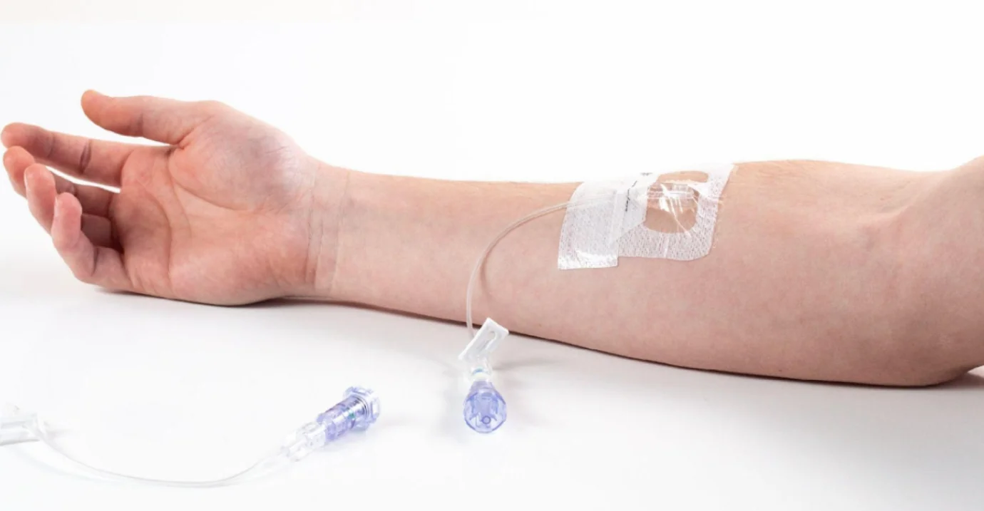 IV line taped to a forearm