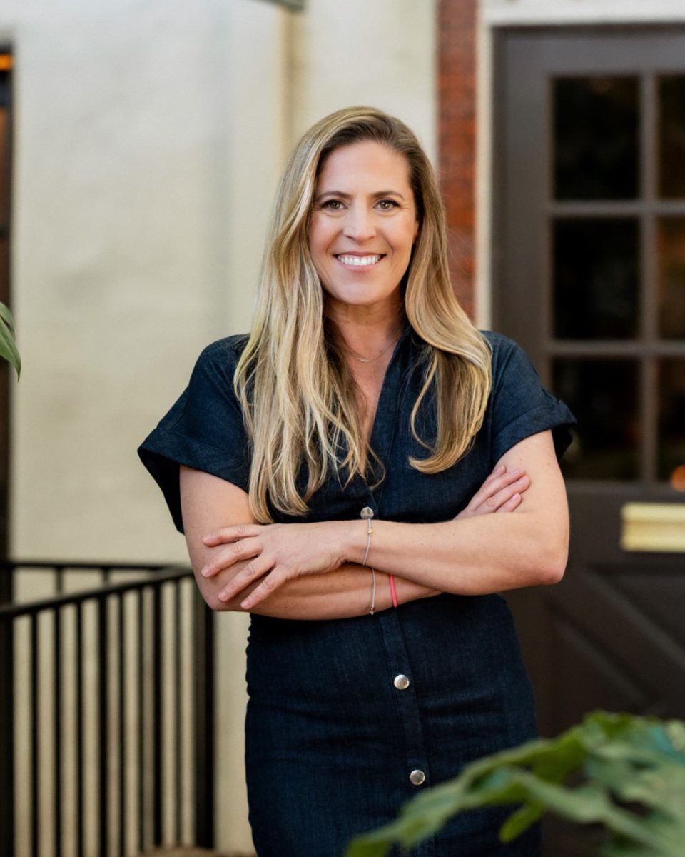 Stephanie Clegg, founder of The Monarch Soul, standing arms crossed outside the Coronado studio
